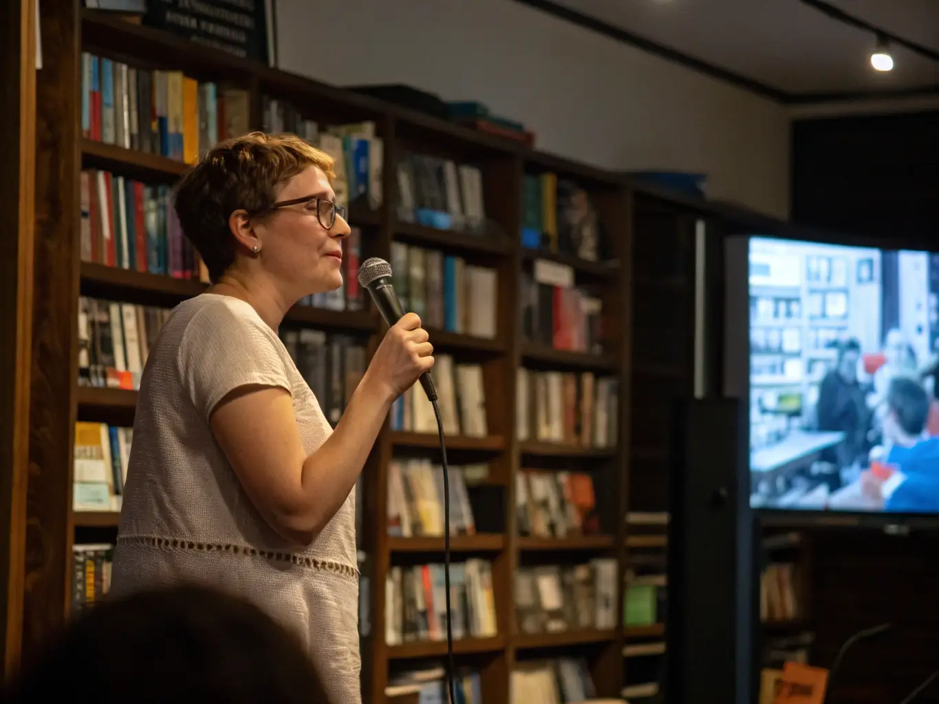 Young advocates presenting a policy proposal at a community forum, with housing models displayed nearby, representing the Housing and Policy Advocacy program.
